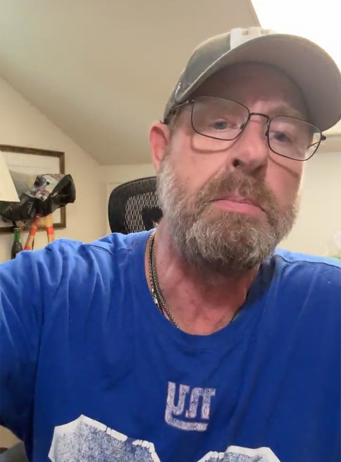 Man with glasses and cap in home office setting, looking serious, related to ChatGPT accused of turning son against mother. Man with glasses and cap in home office setting, looking serious, related to ChatGPT accused of turning son against mother.