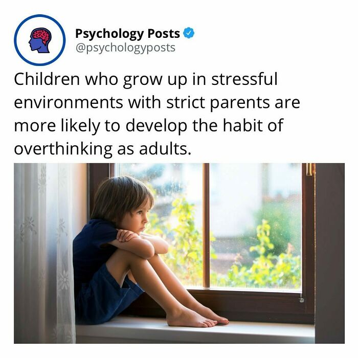 Child sitting thoughtfully by a window, illustrating a psychology fact about overthinking from stressful childhood environments.