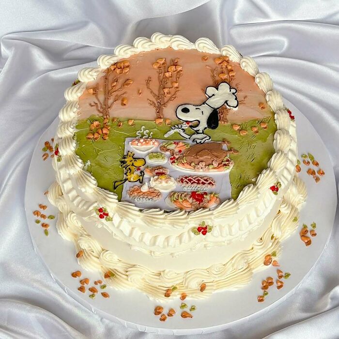 Round cake with Snoopy character as a chef, decorated with detailed frosting showing masterfully crafted cake creativity.