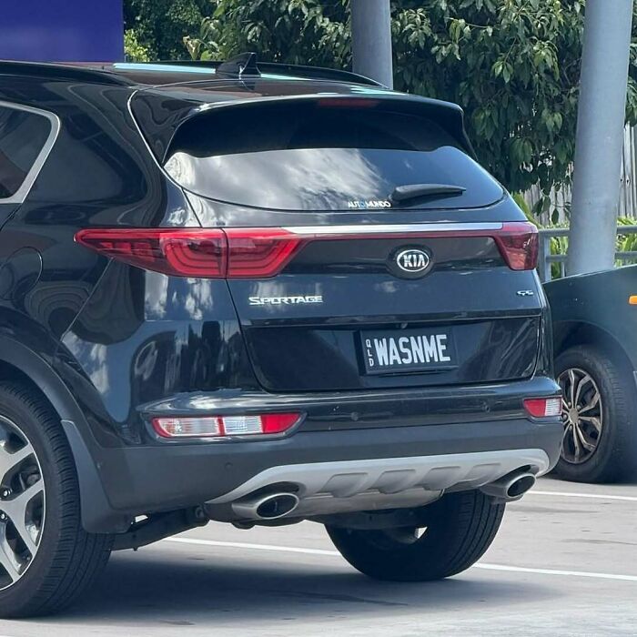 Black Kia Sportage with a hilarious personalized license plate reading WASNME, drawing attention and double takes.