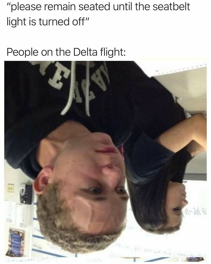 Upside-down photo of two people sitting, illustrating a random meme about Delta flight seatbelt instructions to spice up life boredom.