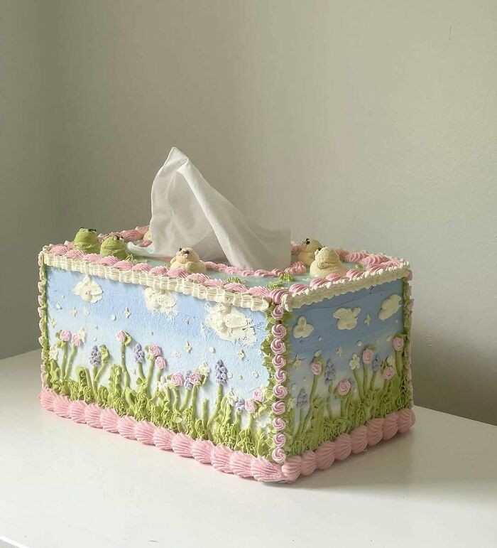 Tissue box designed as a masterfully crafted cake with floral and cloud decorations showcasing creativity.