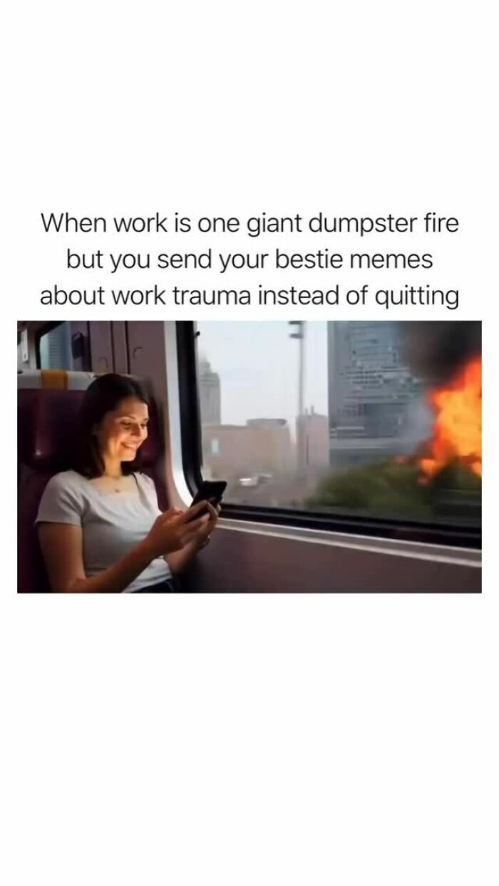 Woman smiling at phone on train while fire burns outside window, illustrating random memes about work trauma and boredom.
