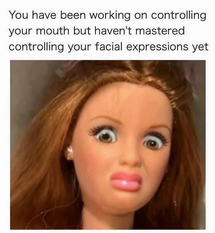 Doll with wide eyes and pursed lips, illustrating humor in controlling facial expressions in reality memes.