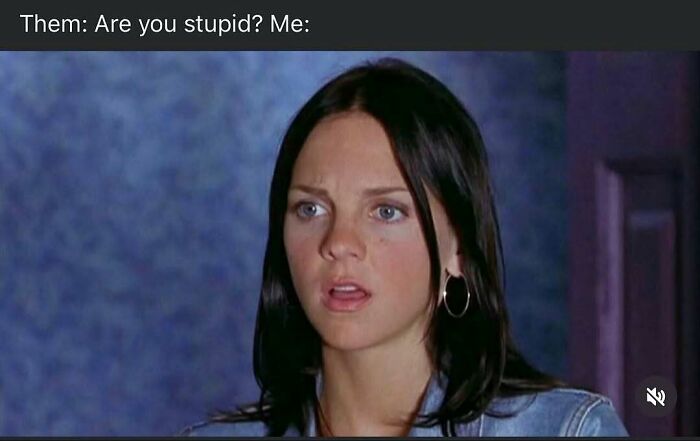 Young woman with dark hair and hoop earrings making a confused face in a humorous meme about handling reality with humor.