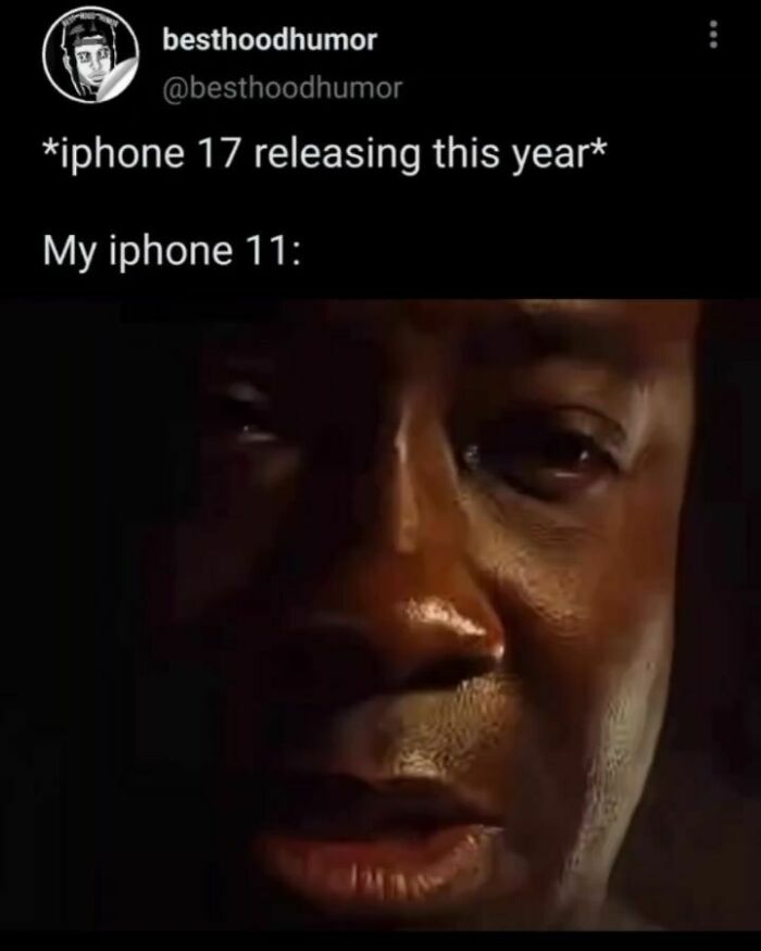 Close-up of a man's emotional face in low light, paired with a humorous caption about iPhone 17 and iPhone 11 meme.