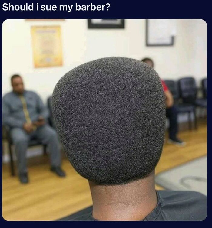 Man with unusually shaped flat top haircut in barbershop waiting area, a funny meme from Know Your Meme collection.