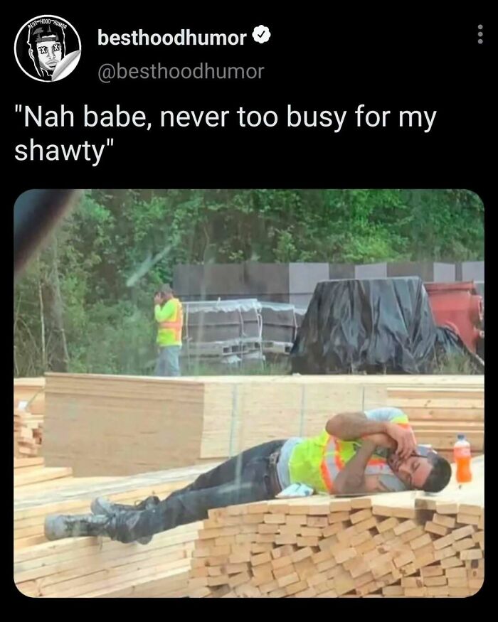 Construction worker lying on wood stacks while talking on phone, illustrating memes that have no reason to be this funny.