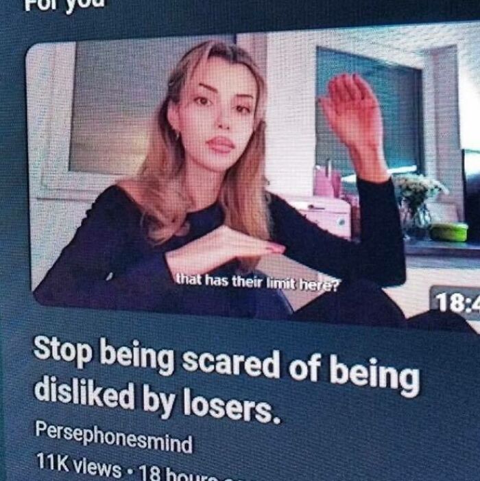 Young woman in a meme video, expressing confidence with a caption about not fearing being disliked by losers.