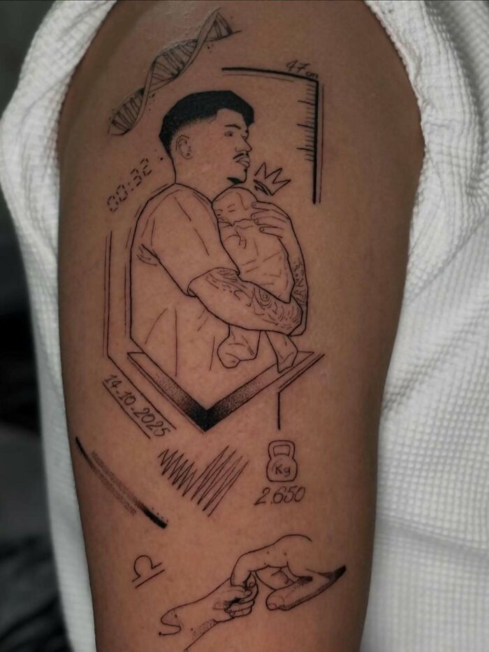 Tattoo of a father holding a baby surrounded by symbolic elements, showcasing wholesome tattoos with meaningful ink.