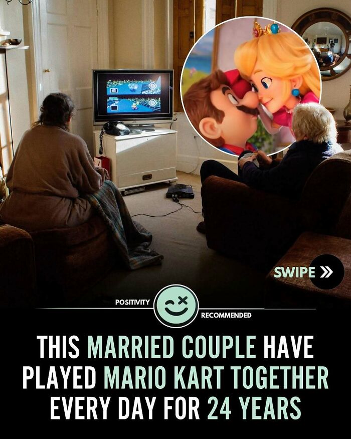 Elderly married couple playing Mario Kart together in their living room, showcasing positivity and wholesome moments.