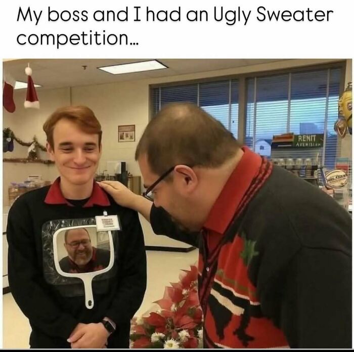 Two men in an office wearing ugly sweaters, one with a mirror showing the other's face, humor in reality memes.