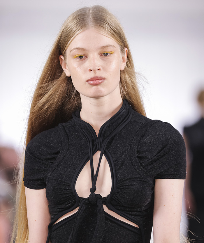 Young woman with long blonde hair wearing a black cut-out top, representing tragic mental illness awareness. Young woman with long blonde hair wearing a black cut-out top, representing tragic mental illness awareness.