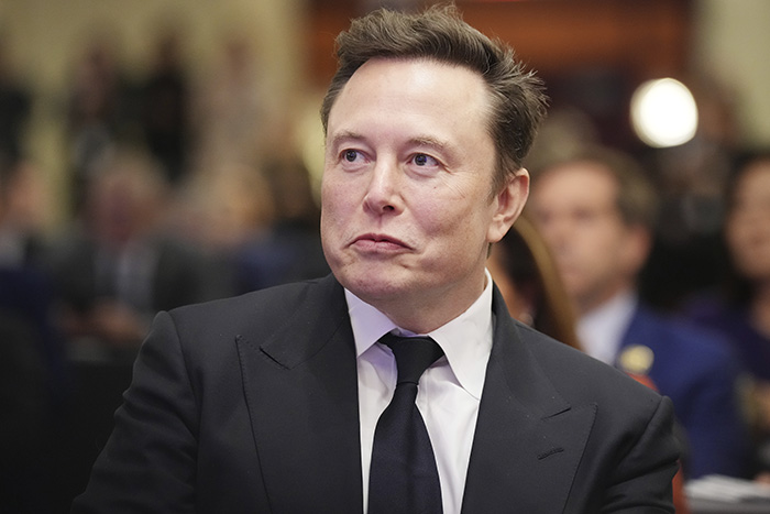 Elon Musk in a black suit and tie at a formal event amid discussions on tragic mental illness and public outrage. Elon Musk in a black suit and tie at a formal event amid discussions on tragic mental illness and public outrage.