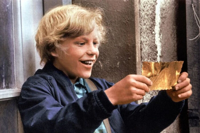 Young boy excitedly holding a shiny gold piece, illustrating a once famous regular job in a nostalgic setting.