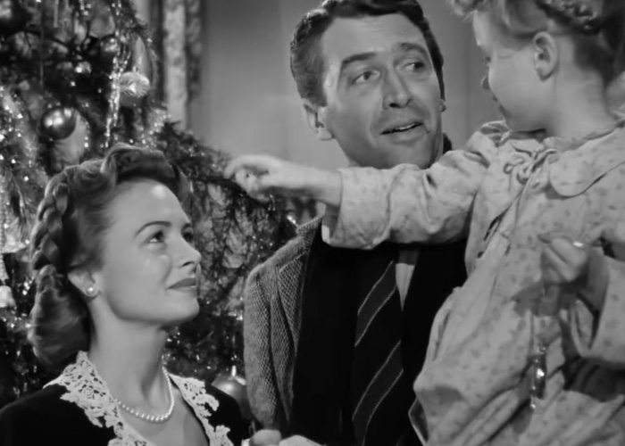 Black and white scene from classic Christmas movie with family by decorated tree, highlighting beloved Christmas classic controversy. Black and white scene from classic Christmas movie with family by decorated tree, highlighting beloved Christmas classic controversy.