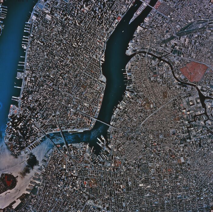 Aerial view of a dense urban area with water channels, illustrating the concept of urban legends in city settings.