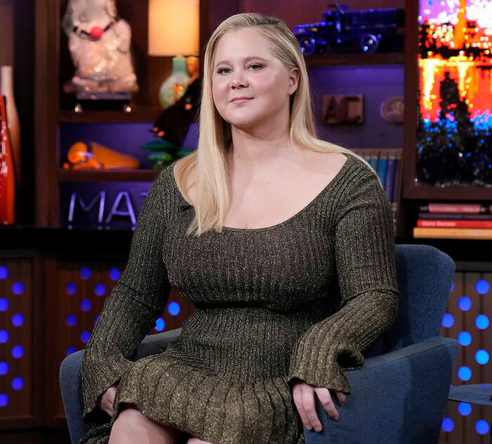 Amy Schumer seated indoors wearing a shimmery green dress, showing off dramatic weight loss during a TV interview. Amy Schumer seated indoors wearing a shimmery green dress, showing off dramatic weight loss during a TV interview.
