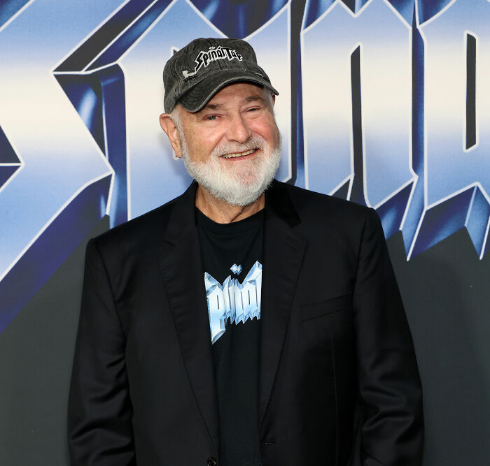 Rob Reiner smiling at an event, wearing a black jacket and hat, highlighting MAGA hypocrisy discussions. Rob Reiner smiling at an event, wearing a black jacket and hat, highlighting MAGA hypocrisy discussions.