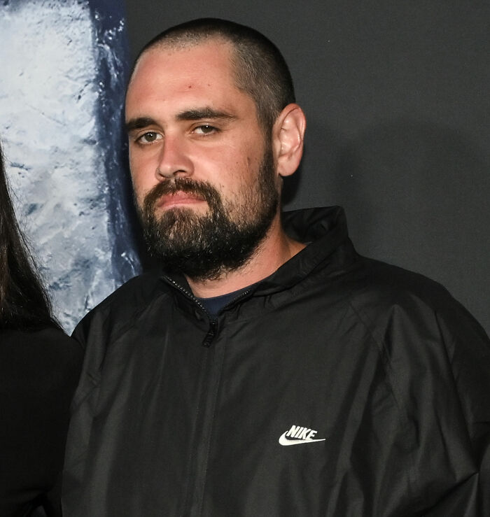 Nick Reiner wearing a black Nike jacket, looking serious during a tense moment at Conan O&rsquo;Brien&rsquo;s party.