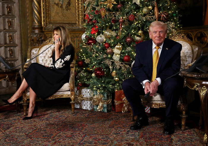 Donald Trump and Ivanka Trump seated near a decorated Christmas tree while making phone calls on Christmas Eve. Donald Trump and Ivanka Trump seated near a decorated Christmas tree while making phone calls on Christmas Eve.