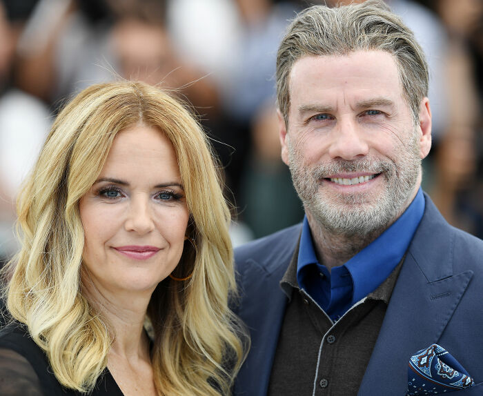 Riley Keough and John Travolta posing together at an event, related to court docs and biological mother claims. Riley Keough and John Travolta posing together at an event, related to court docs and biological mother claims.