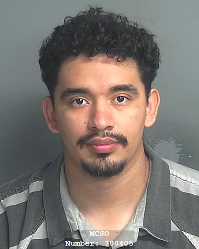 Mugshot of a man with curly hair and a goatee, related to heroic Texas dad rescuing kidnapped daughter in the woods. Mugshot of a man with curly hair and a goatee, related to heroic Texas dad rescuing kidnapped daughter in the woods.