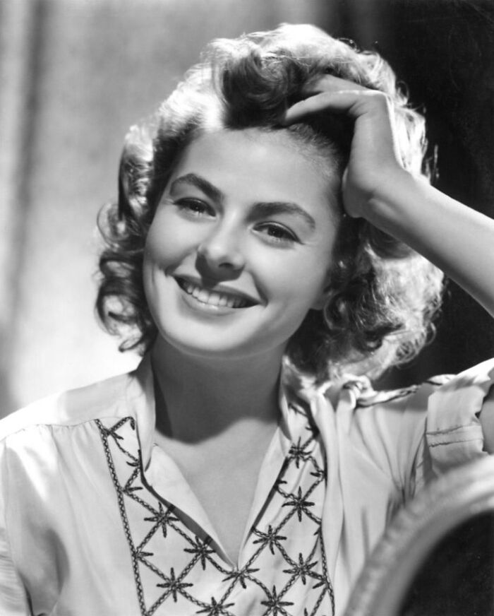 Vintage black and white portrait of a smiling young female celebrity in blouse, soft lighting, Cancel Culture Victims