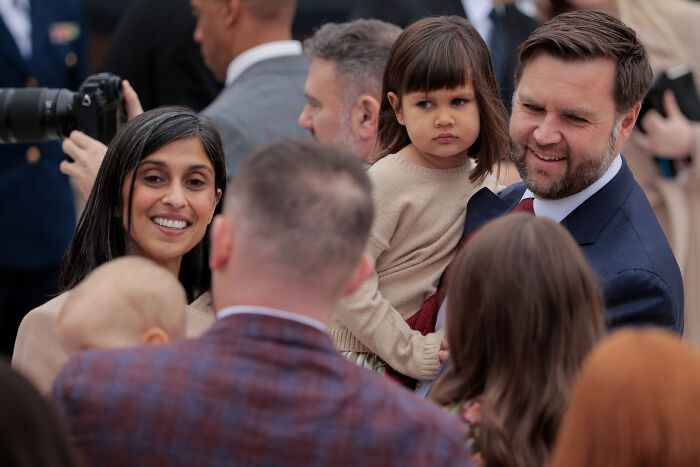 JD Vance smiling and holding a child, surrounded by people amid marriage speculation and viral hug discussions. JD Vance smiling and holding a child, surrounded by people amid marriage speculation and viral hug discussions.