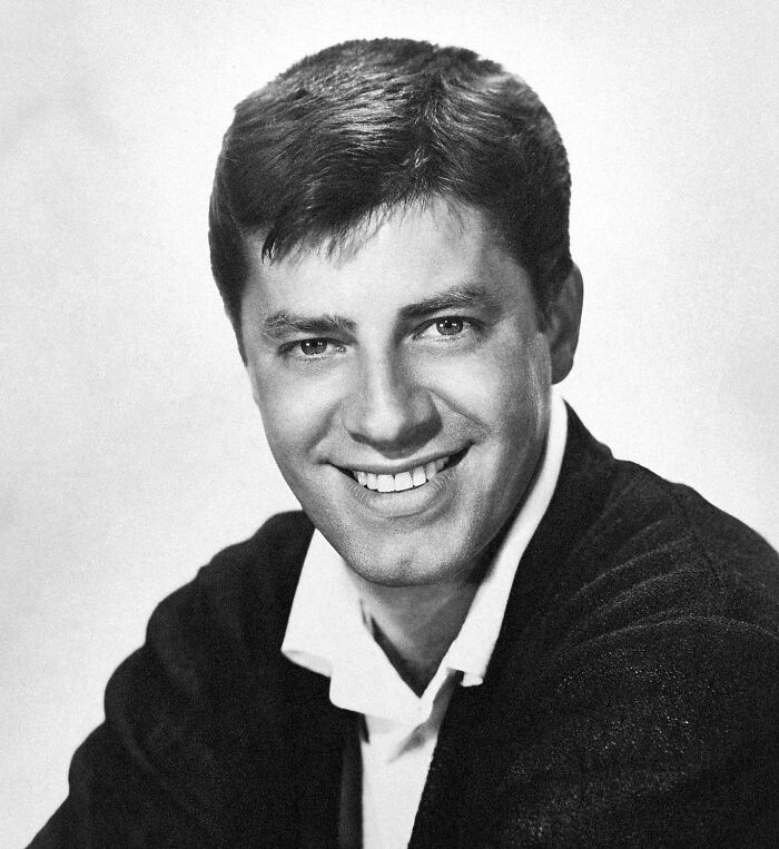 Young man smiling in a black and white portrait photo, related to banned stars from the Tonight Show by Johnny Carson. Young man smiling in a black and white portrait photo, related to banned stars from the Tonight Show by Johnny Carson.