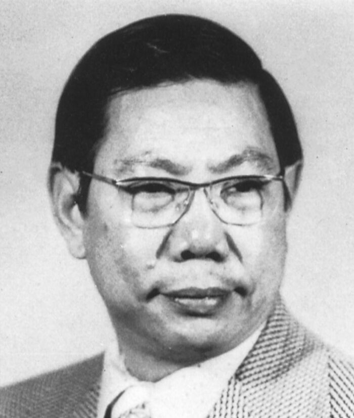 Black and white photo of a man wearing glasses and a suit, related to people sharing historical facts unknown until recently.