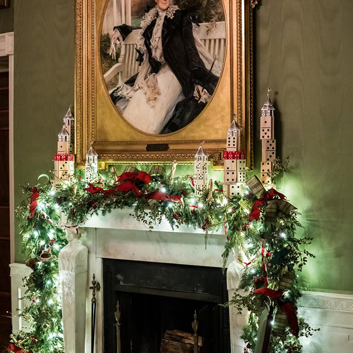 Christmas mantel decorated with lights and red bows featuring Melania Trump’s new Christmas ornament known for its high cost. Christmas mantel decorated with lights and red bows featuring Melania Trump’s new Christmas ornament known for its high cost.