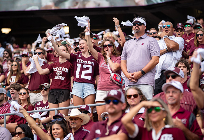 Crowd at a Texas A&M game, showing fans cheering in maroon, related to mom of late cheerleader refusing cops' ruling. Crowd at a Texas A&M game, showing fans cheering in maroon, related to mom of late cheerleader refusing cops' ruling.