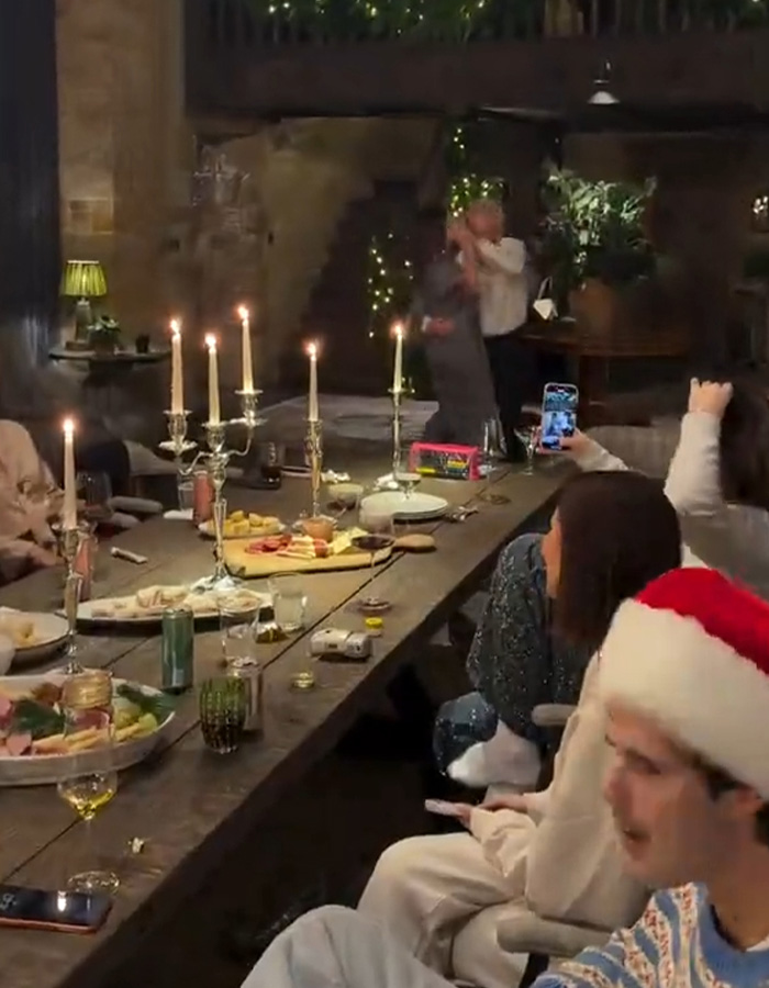 Holiday gathering with festive candles, people celebrating indoors, fans discuss Brooklyn&rsquo;s wife Nicola Peltz and Victoria posts.