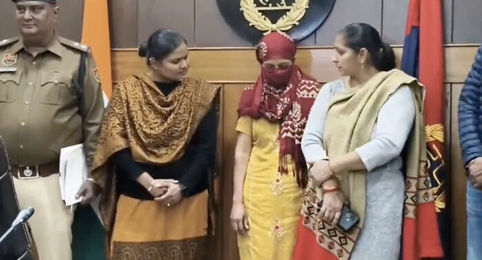 Woman in headscarf standing with family and police, linked to horrifying wedding tragedy and missing child's body discovery. Woman in headscarf standing with family and police, linked to horrifying wedding tragedy and missing child's body discovery.