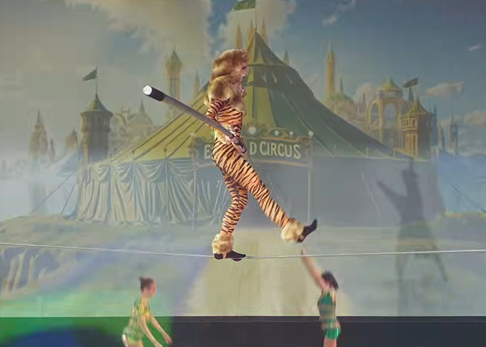 Performer in a tiger costume walking a tightrope during a Wizard of Oz performance amid audience outrage and walkouts. Performer in a tiger costume walking a tightrope during a Wizard of Oz performance amid audience outrage and walkouts.