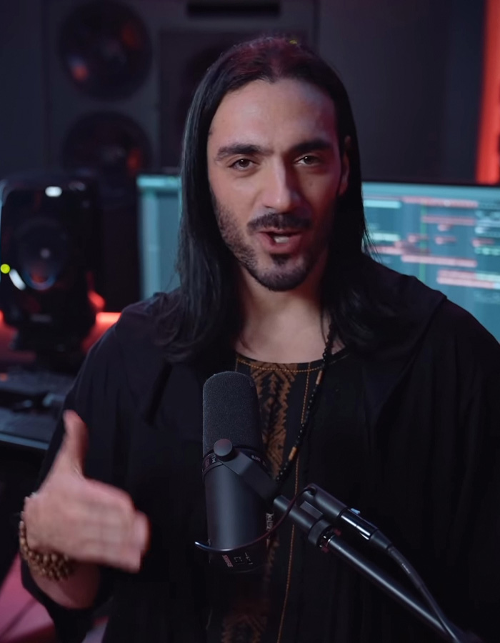 Man with long hair performing Mongolian jingle bells throat singing in a recording studio with microphone and audio equipment. Man with long hair performing Mongolian jingle bells throat singing in a recording studio with microphone and audio equipment.