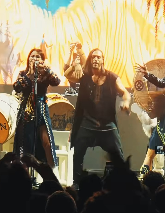 Performers on stage showcasing Mongolian throat singing with traditional instruments during a viral Christmas anthem event.