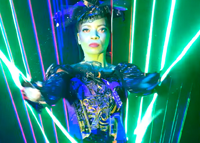 Performer in a Wizard Of Oz stage show wearing a dark costume with green laser lights illuminating the background. Performer in a Wizard Of Oz stage show wearing a dark costume with green laser lights illuminating the background.