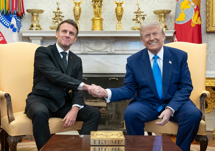 French soldier's odd behavior behind Emmanuel Macron during meeting with Donald Trump sparks France conspiracy theories.