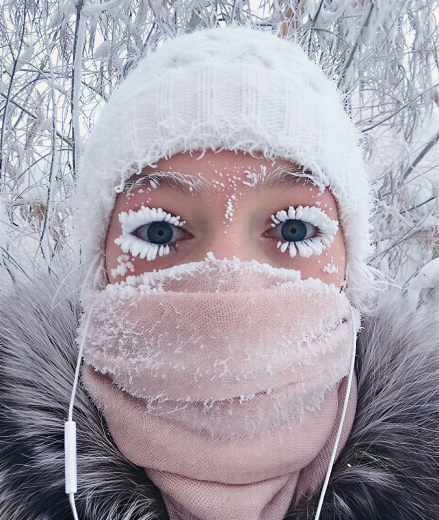 Person wearing winter hat and scarf with frost on eyelashes in one of the most dangerous places in the world to visit.