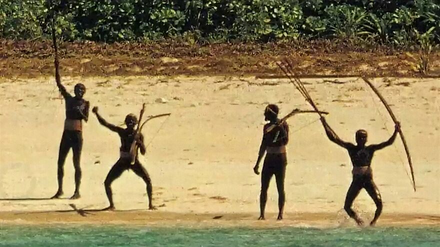 Indigenous people on a beach holding spears, illustrating one of the most dangerous places in the world to visit right now