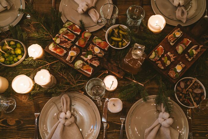 Cozy dinner table set with candles, appetizers, and festive decorations inviting calm in different scenarios.