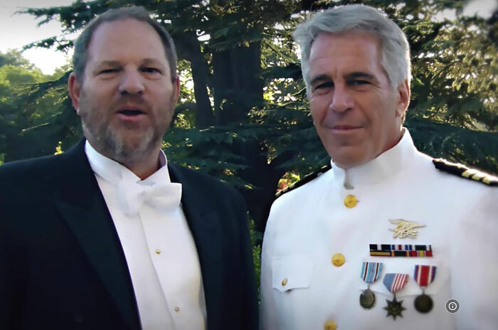 Harvey Weinstein and another man in formal attire outdoors, related to Dame Judi Dench's defense controversy.