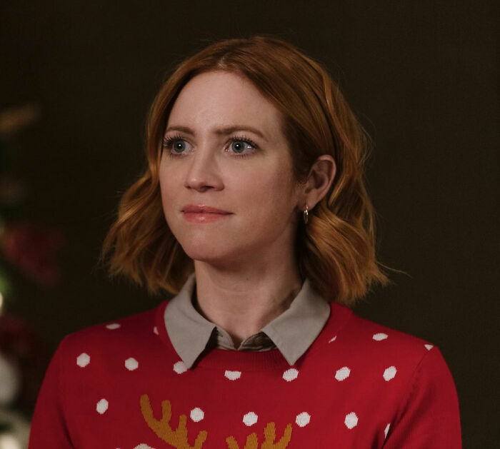 Britanny Snow with short red hair wearing a festive red sweater, responding to plastic surgery rumors in a candid moment. Britanny Snow with short red hair wearing a festive red sweater, responding to plastic surgery rumors in a candid moment.