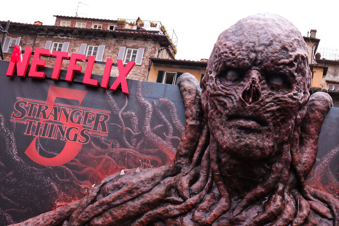 Large grotesque Stranger Things monster statue outside a Netflix building, highlighting a major episode blunder exposed by fans.