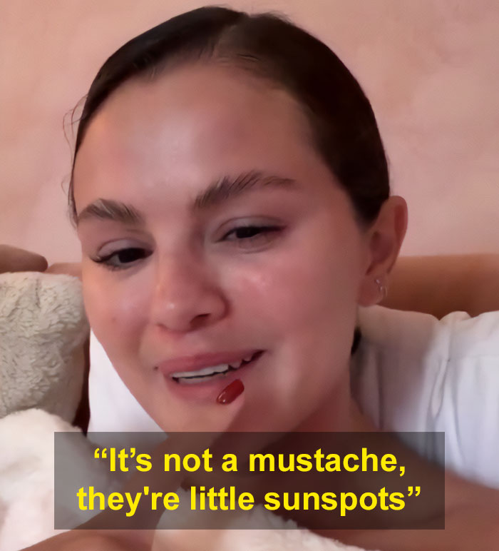 Selena Gomez responding to fan about how she shaves her mustache while smiling indoors with natural makeup. Selena Gomez responding to fan about how she shaves her mustache while smiling indoors with natural makeup.