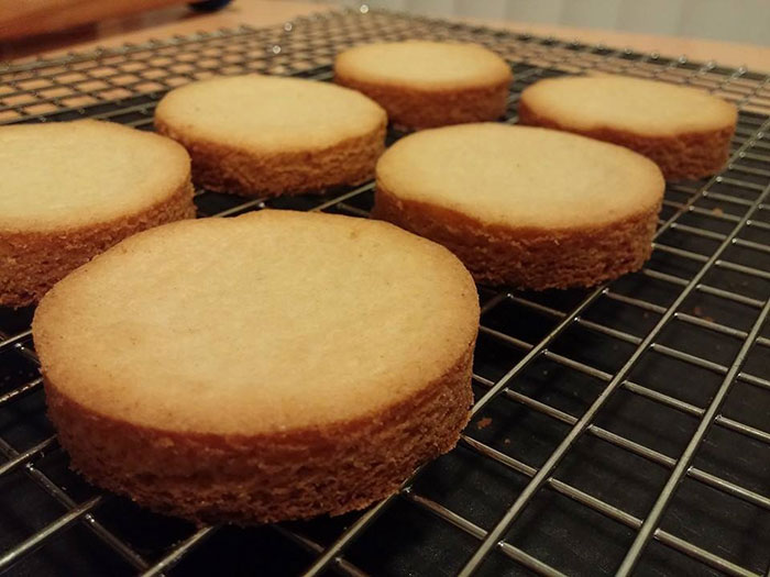 Freshly baked round pastries cooling on a wire rack, highlighting a boyfriend's passion for pastries in a relationship. Freshly baked round pastries cooling on a wire rack, highlighting a boyfriend's passion for pastries in a relationship.