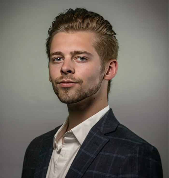 Young wealthy US student wearing a dark blazer and white shirt posing confidently against a neutral background. Young wealthy US student wearing a dark blazer and white shirt posing confidently against a neutral background.