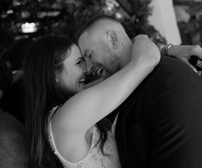 Couple joyfully embracing at wedding celebration amid Gordon Ramsay speech and family drama.